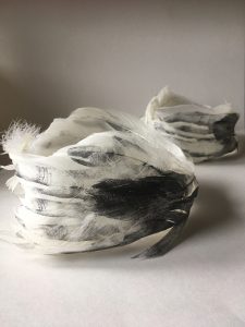 swans feather vessels with cupped hands screen printed onto them.