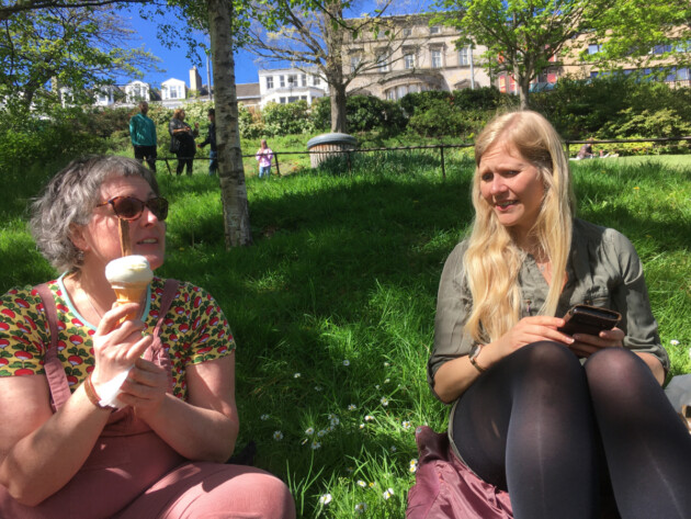 Alys Mendus and Jess Erb eating ice cream in park in Edinburgh