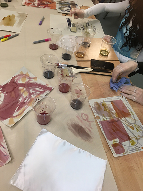 Workshop for textile triptych showing painting dyes on paper