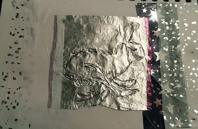 collage of sparkly papers and a impression of a hare on silver paper.