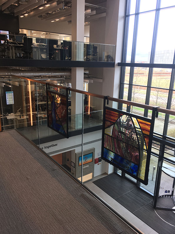 side angle view of leaded panels affixed to glass balustrade